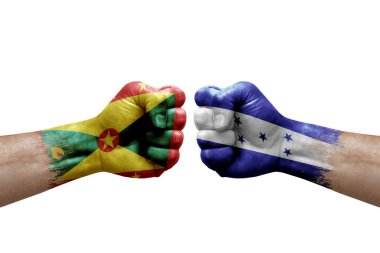 Two hands punch to each others on white background. Country flags painted fists, conflict crisis concept between grenada and honduras