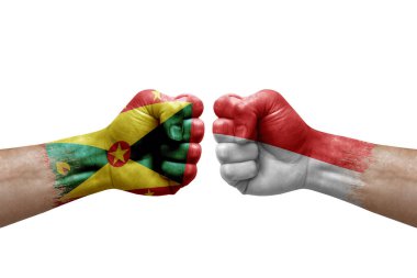 Two hands punch to each others on white background. Country flags painted fists, conflict crisis concept between grenada and indonesia