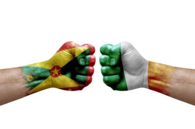 Two hands punch to each others on white background. Country flags painted fists, conflict crisis concept between grenada and ireland