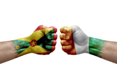 Two hands punch to each others on white background. Country flags painted fists, conflict crisis concept between grenada and ivory coast