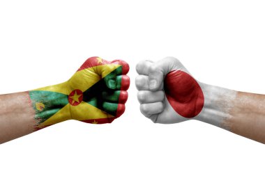Two hands punch to each others on white background. Country flags painted fists, conflict crisis concept between grenada and japan