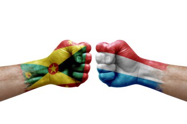 Two hands punch to each others on white background. Country flags painted fists, conflict crisis concept between grenada and luxembourg