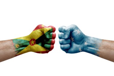 Two hands punch to each others on white background. Country flags painted fists, conflict crisis concept between grenada and micronesia
