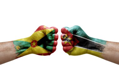 Two hands punch to each others on white background. Country flags painted fists, conflict crisis concept between grenada and mozambique