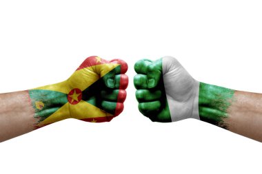 Two hands punch to each others on white background. Country flags painted fists, conflict crisis concept between grenada and nigeria