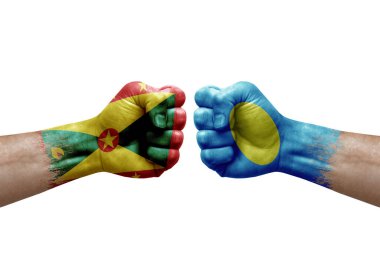 Two hands punch to each others on white background. Country flags painted fists, conflict crisis concept between grenada and palau
