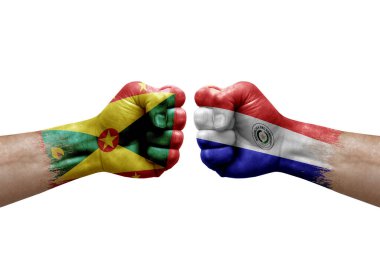 Two hands punch to each others on white background. Country flags painted fists, conflict crisis concept between grenada and paraguay