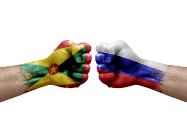 Two hands punch to each others on white background. Country flags painted fists, conflict crisis concept between grenada and russia