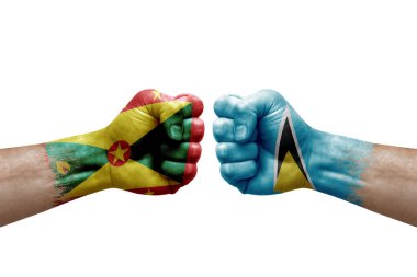 Two hands punch to each others on white background. Country flags painted fists, conflict crisis concept between grenada and saint lucia