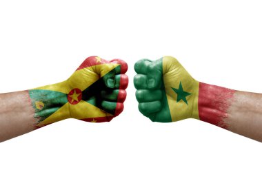 Two hands punch to each others on white background. Country flags painted fists, conflict crisis concept between grenada and senegal