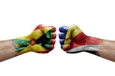 Two hands punch to each others on white background. Country flags painted fists, conflict crisis concept between grenada and seychelles