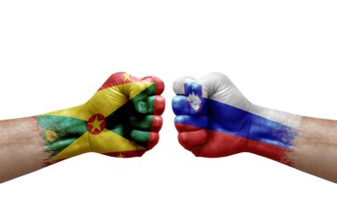 Two hands punch to each others on white background. Country flags painted fists, conflict crisis concept between grenada and slovenia