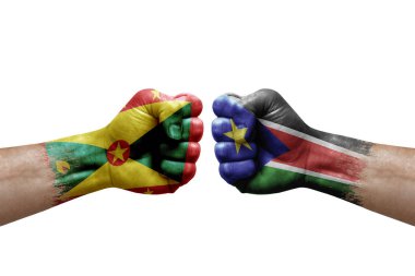 Two hands punch to each others on white background. Country flags painted fists, conflict crisis concept between grenada and south sudan