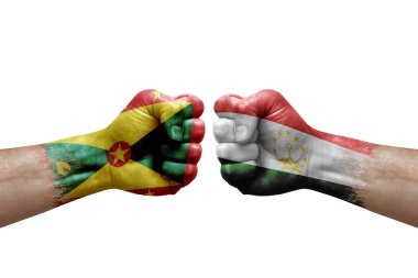 Two hands punch to each others on white background. Country flags painted fists, conflict crisis concept between grenada and tajikistan