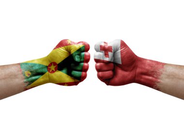 Two hands punch to each others on white background. Country flags painted fists, conflict crisis concept between grenada and tonga