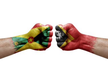 Two hands punch to each others on white background. Country flags painted fists, conflict crisis concept between grenada and timor leste