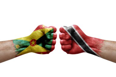Two hands punch to each others on white background. Country flags painted fists, conflict crisis concept between grenada and tobago