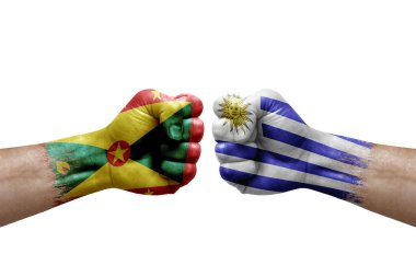 Two hands punch to each others on white background. Country flags painted fists, conflict crisis concept between grenada and uruguay