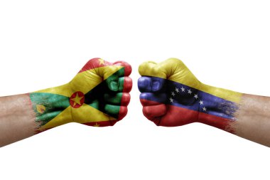 Two hands punch to each others on white background. Country flags painted fists, conflict crisis concept between grenada and venezuela