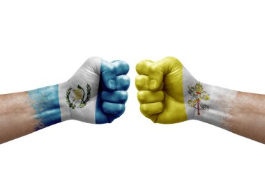 Two hands punch to each others on white background. Country flags painted fists, conflict crisis concept between guatemala and holy see