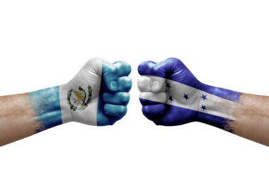 Two hands punch to each others on white background. Country flags painted fists, conflict crisis concept between guatemala and honduras