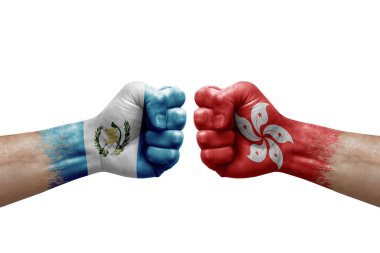 Two hands punch to each others on white background. Country flags painted fists, conflict crisis concept between guatemala and hong kong