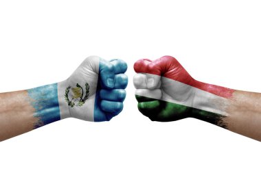 Two hands punch to each others on white background. Country flags painted fists, conflict crisis concept between guatemala and hungary