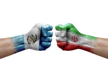 Two hands punch to each others on white background. Country flags painted fists, conflict crisis concept between guatemala and iran