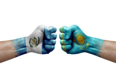 Two hands punch to each others on white background. Country flags painted fists, conflict crisis concept between guatemala and kazakhstan