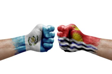 Two hands punch to each others on white background. Country flags painted fists, conflict crisis concept between guatemala and kiribati