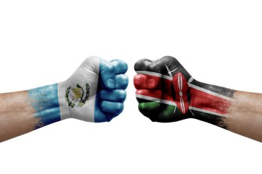 Two hands punch to each others on white background. Country flags painted fists, conflict crisis concept between guatemala and kenya