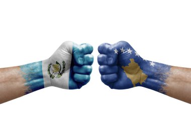 Two hands punch to each others on white background. Country flags painted fists, conflict crisis concept between guatemala and kosovo