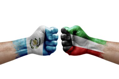 Two hands punch to each others on white background. Country flags painted fists, conflict crisis concept between guatemala and kuwait