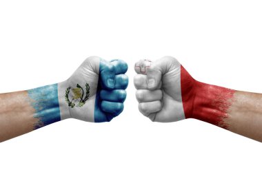 Two hands punch to each others on white background. Country flags painted fists, conflict crisis concept between guatemala and malta