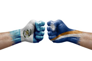 Two hands punch to each others on white background. Country flags painted fists, conflict crisis concept between guatemala and marshall islands