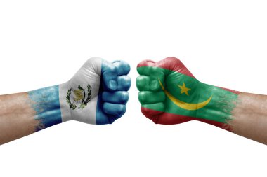 Two hands punch to each others on white background. Country flags painted fists, conflict crisis concept between guatemala and mauritania