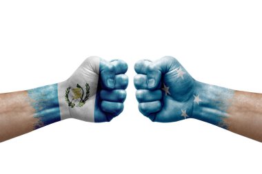 Two hands punch to each others on white background. Country flags painted fists, conflict crisis concept between guatemala and micronesia