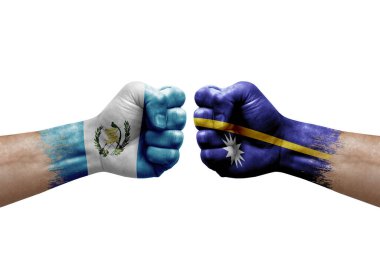 Two hands punch to each others on white background. Country flags painted fists, conflict crisis concept between guatemala and nauru