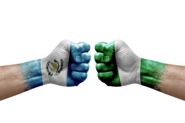 Two hands punch to each others on white background. Country flags painted fists, conflict crisis concept between guatemala and nigeria