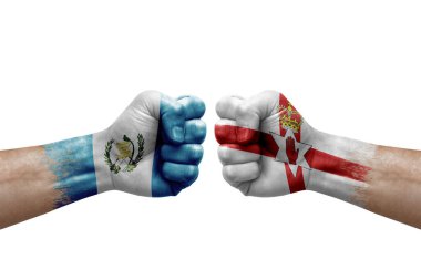 Two hands punch to each others on white background. Country flags painted fists, conflict crisis concept between guatemala and ireland