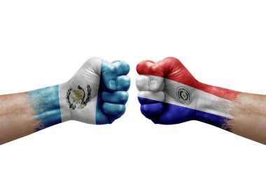 Two hands punch to each others on white background. Country flags painted fists, conflict crisis concept between guatemala and paraguay