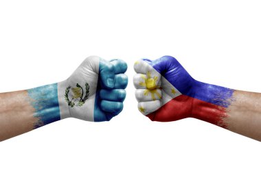 Two hands punch to each others on white background. Country flags painted fists, conflict crisis concept between guatemala and philippines