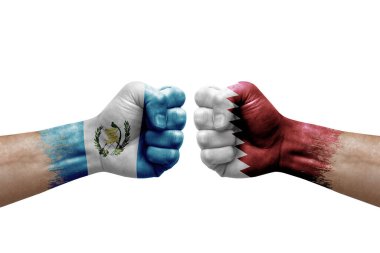 Two hands punch to each others on white background. Country flags painted fists, conflict crisis concept between guatemala and qatar