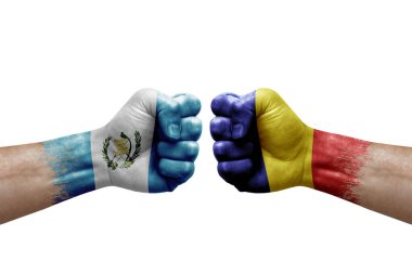 Two hands punch to each others on white background. Country flags painted fists, conflict crisis concept between guatemala and romania