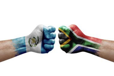 Two hands punch to each others on white background. Country flags painted fists, conflict crisis concept between guatemala and south africa