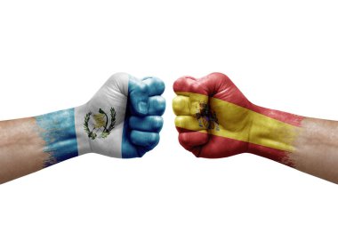 Two hands punch to each others on white background. Country flags painted fists, conflict crisis concept between guatemala and spain