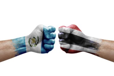 Two hands punch to each others on white background. Country flags painted fists, conflict crisis concept between guatemala and thailand