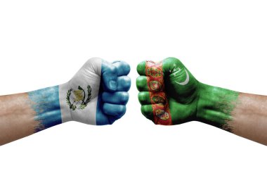 Two hands punch to each others on white background. Country flags painted fists, conflict crisis concept between guatemala and turkmenistan