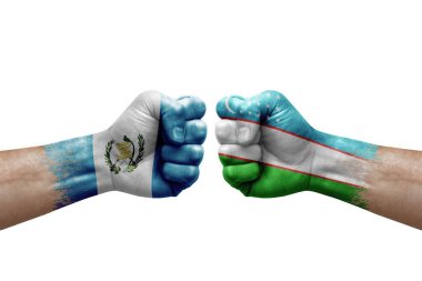 Two hands punch to each others on white background. Country flags painted fists, conflict crisis concept between guatemala and uzbekistan
