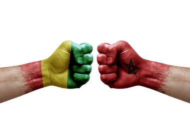 Two hands punch to each others on white background. Country flags painted fists, conflict crisis concept between guinea and morocco